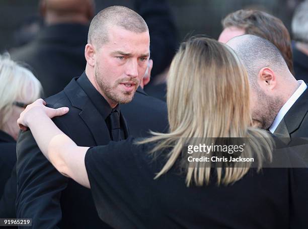 Andrew Cowles is comforted by friends as he attends the funeral of Boyzone singer Stephen Gately at St Laurence O'Toole Church on October 17, 2009 in...