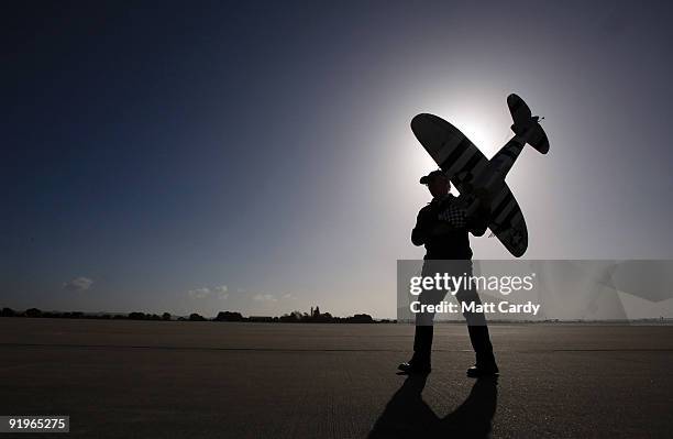 Model aircraft maker carries his radio controlled plane onto the runway prior to a flying display at RNAS Yeovilton on October 17, 2009 in Yeovil,...