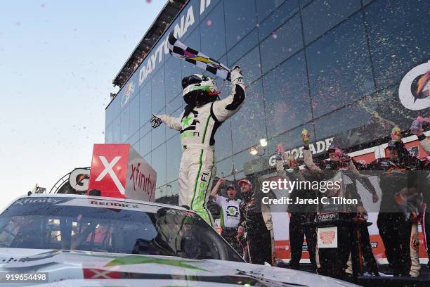 Tyler Reddick, driver of the BurgerFi Chevrolet, celebrates in Victory Lane after winning the NASCAR Xfinity Series PowerShares QQQ 300 at Daytona...