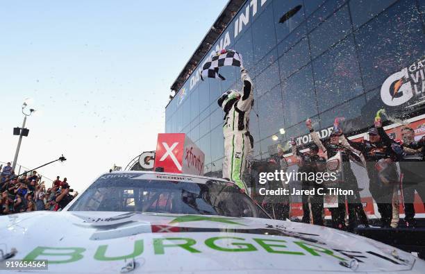 Tyler Reddick, driver of the BurgerFi Chevrolet, celebrates in Victory Lane after winning the NASCAR Xfinity Series PowerShares QQQ 300 at Daytona...