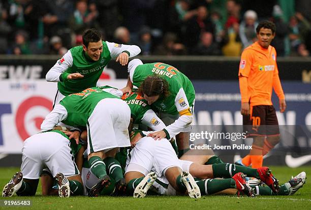 Per Mertesacker of Bremen celebrates scoring his team's second goal with team mates during the Bundesliga match between SV Werder Bremen and 1899...