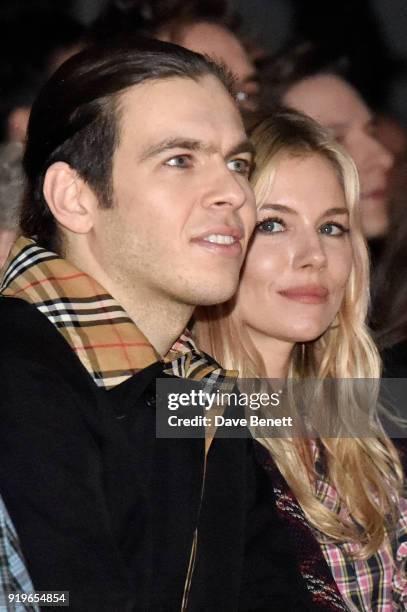 James Righton and Sienna Miller wearing Burberry at the Burberry February 2018 show during London Fashion Week at Dimco Buildings on February 17,...