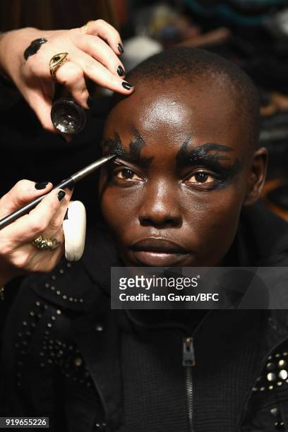 Grace Bol has makeup applied backstage ahead of the Gareth Pugh show during London Fashion Week February 2018 at Ambika P3 on February 17, 2018 in...