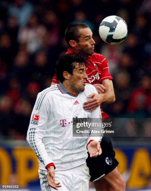Luca Toni of Muenchen and Pavel Krmas of Freiburg jump for a header during the Bundesliga match between SC Freiburg and Bayern Muenchen at the...