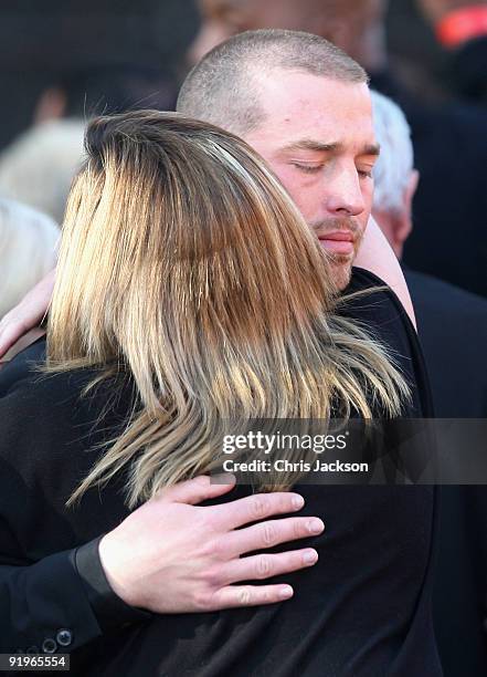 Andrew Cowles is comforted by friends as he attends the funeral of Boyzone singer Stephen Gately at St Laurence O'Toole Church on October 17, 2009 in...