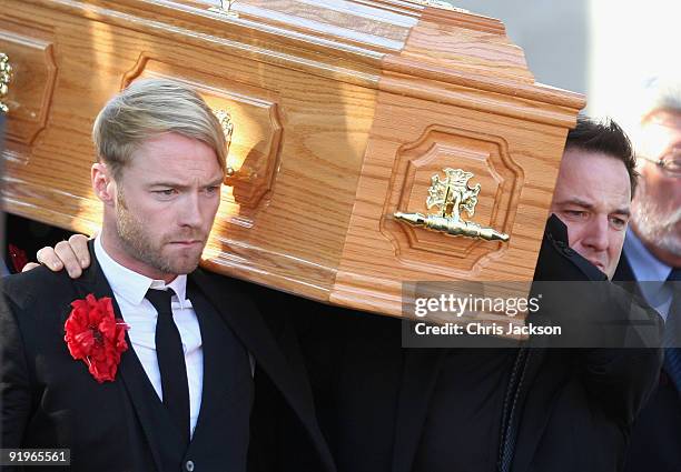 Ronan Keating, Mikey Graham and Shane Lynch carry out the coffin after the funeral of Boyzone singer Stephen Gately at St Laurence O'Toole Church on...