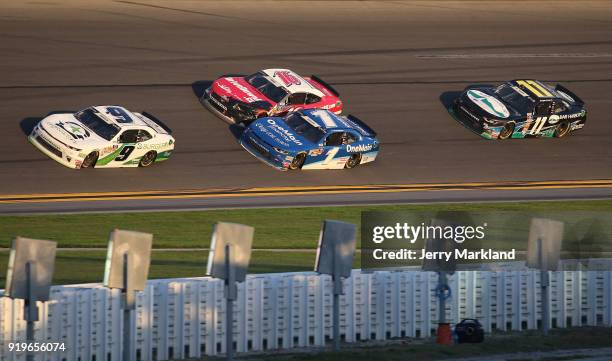 Tyler Reddick, driver of the BurgerFi Chevrolet, and Elliott Sadler, driver of the OneMain Financial Chevrolet, race to the finish line during the...