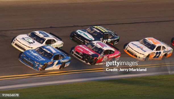 Tyler Reddick, driver of the BurgerFi Chevrolet, and Elliott Sadler, driver of the OneMain Financial Chevrolet, race to the finish line during the...