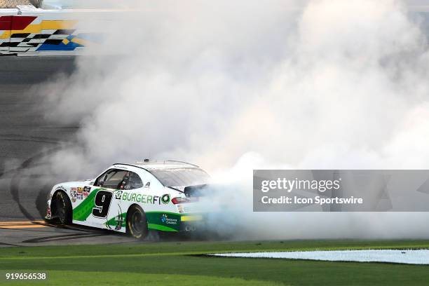 Tyler Reddick, JR Motorsports, BurgerFi Chevrolet Camaro does a burnout after winning the Powershares QQQ 300 NASCAR Xfinity Series race on February...