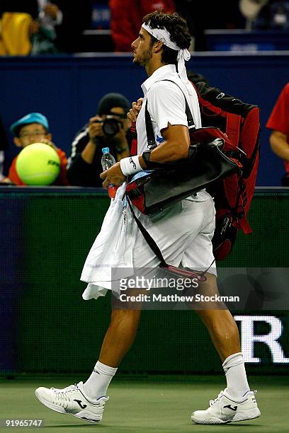 Feliciano Lopez of Spain leaves the court after retiring from his match in the second set against Rafael Nadal during the semifinal round on day...