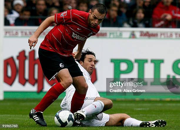 Luca Toni of Muenchen is challenged by Pavel Krmas of Freiburg during the Bundesliga match between SC Freiburg and Bayern Muenchen at the Badenova...