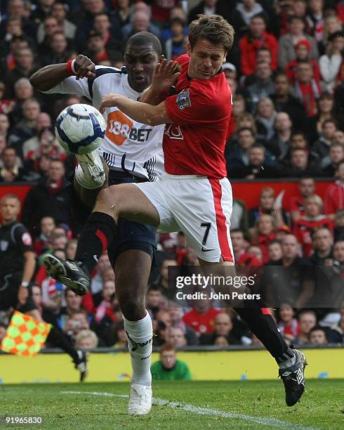 Michael Owen of Manchester United clashes with Jlloyd Samuel of Bolton Wanderers during the FA Barclays Premier League match between Manchester...