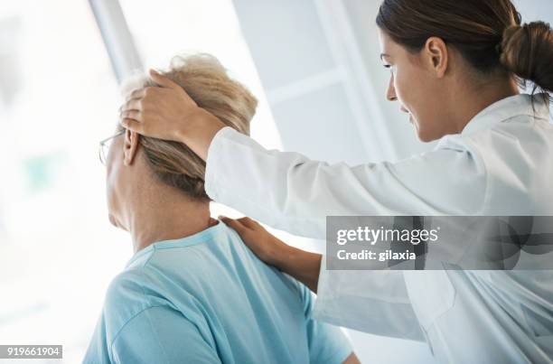 neck pain medical exam. - calcification stock pictures, royalty-free photos & images