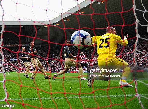 Darren Bent of Sunderland watches as his shot goes between Glen Johnson and Pepe Reina of Liverpool in to the goal during the Barclays Premier League...