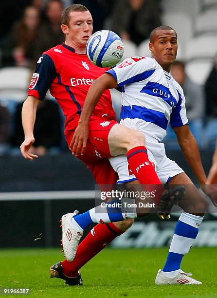 Jay Simpson of Queens Park Rangers battles for the ball with Neill Collins of Preston North End during the Coca Cola Championship match between...