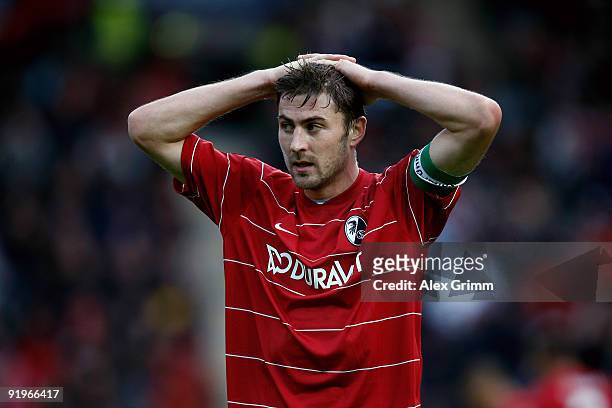 Heiko Butscher of Freiburg reacts after an own goal during the Bundesliga match between SC Freiburg and Bayern Muenchen at the Badenova Stadium on...