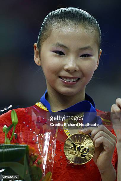 Kexin He of China poses with her gold medal after she won the uneven bars event during the Apparatus Finals on the fifth day of the Artistic...
