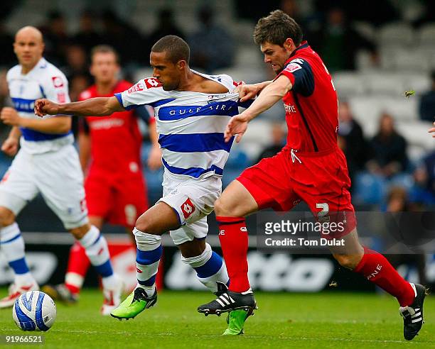 Wayne Routledge of Queens Park Rangers and Michael Hart of Preston North End chase the ball during the Coca Cola Championship match between Queens...