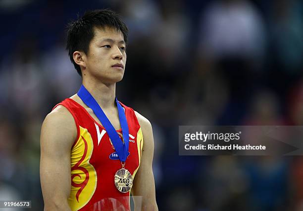 Hongtao Zhang of China poses with his gold medal after he won the pommel horse event during the Apparatus Finals on the fifth day of the Artistic...