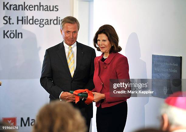 Queen Silvia of Sweden and Walter Bros pose for photographers after the opening ceremony of the first german section in a hospital for dementia...