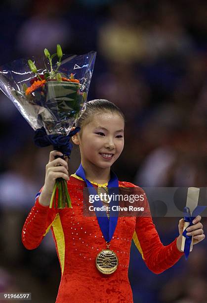 Kexin He of China poses with her gold medal after she won the uneven bars event during the Apparatus Finals on the fifth day of the Artistic...