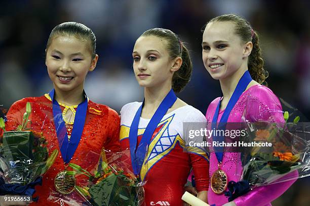 Kexin He of China poses with her gold medal after she won the uneven bars event during the Apparatus Finals on the fifth day of the Artistic...