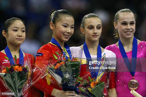 Kexin He of China poses with her gold medal after she won the uneven bars event during the Apparatus Finals on the fifth day of the Artistic...