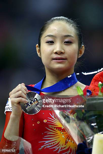 Koko Tsurumi of Japan poses with her silver medal after she came second in the uneven bars event during the Apparatus Finals on the fifth day of the...