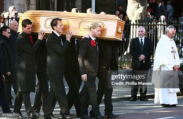 Keith Duffy and Ronan Keating carry the coffin of Boyzone member Stephen Gately on October 17, 2009 in Dublin, Ireland.