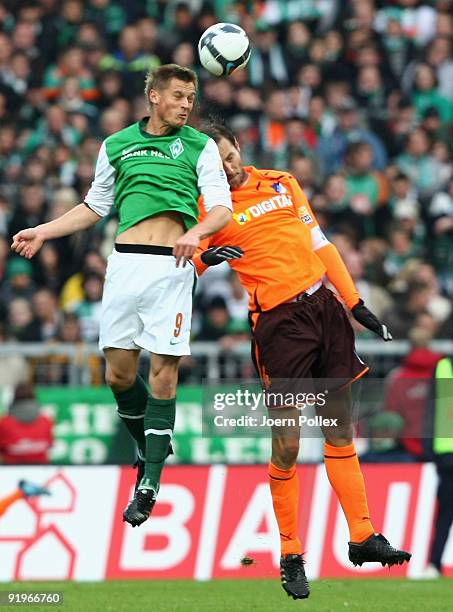 Markus Rosenberg of Bremen and Josip Simunic of Hoffenheim jump for a header during the Bundesliga match between SV Werder Bremen and 1899 Hoffenheim...