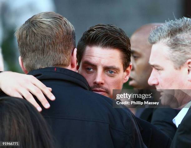 Keith Duffy is comforted at the funeral of Boyzone member Stephen Gately on October 17, 2009 in Dublin, Ireland.