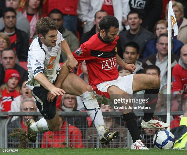 Ryan Giggs of Manchester United clashes with Samuel Ricketts of Bolton Wanderers during the FA Barclays Premier League match between Manchester...