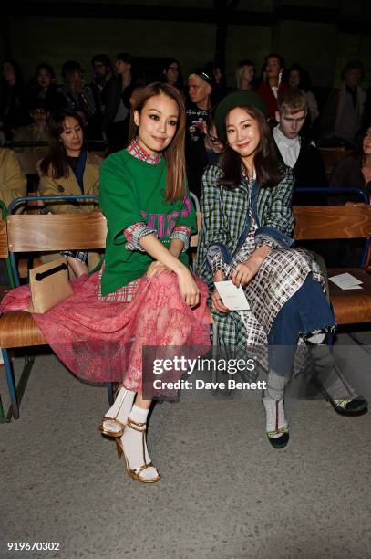 Joey Yung and Ji Woo Choi wearing Burberry at the Burberry February 2018 show during London Fashion Week at Dimco Buildings on February 17, 2018 in...