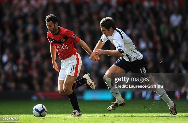 Ryan Giggs of Manchester United battles with Samuel Ricketts of Bolton during the Barclays Premier League match between Manchester United and Bolton...