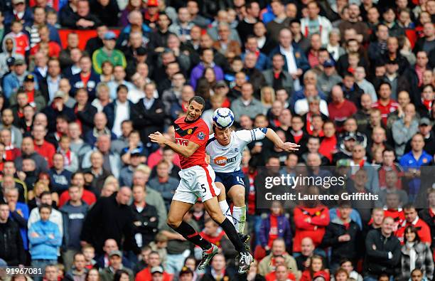 Rio Ferdinand of Manchester United battles with Kevin Davies of Bolton during the Barclays Premier League match between Manchester United and Bolton...