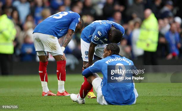 Kevin-Prince Boateng, Aruna Dindane and Frederick Piquionne of Portsmouth look dejected after the Barclays Premier League match between Portsmouth...