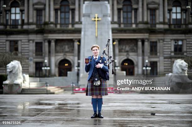 Robyn Ada McKay a bagpiper studying at The Royal Conservatoire of Scotland poses with her passport on January 22, 2018 in Glasgow. On Brexit she...