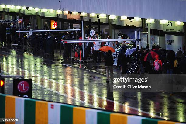 Cars stay in their garages during the rain delayed final practice session prior to qualifying for the Brazilian Formula One Grand Prix at the...