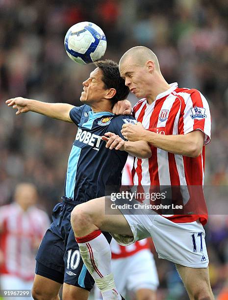 Ryan Shawcross of Stoke jumps for the ball with Guillermo Franco of West Ham during the Barclays Premier League match between Stoke City and West Ham...