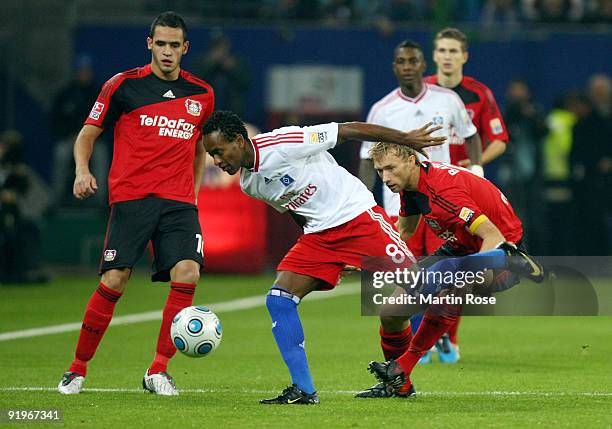 Ze Roberto of Hamburg and Simon Rolfes of Leverkusen battle for the ball during the Bundesliga match between Hamburger SV and Bayer Leverkusen at the...