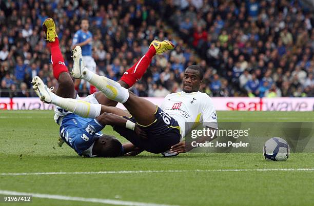 Aruna Dindane of Portsmouth competes against Sebastien Bassong of Tottenham Hotspur during the Barclays Premier League match between Portsmouth and...