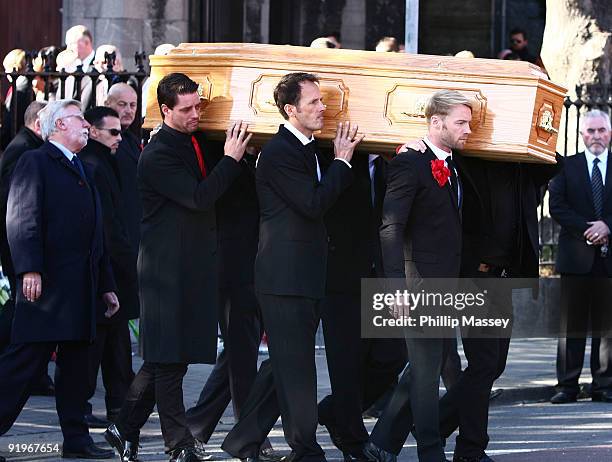 Keith Duffy and Ronan Keating carry the coffin of Boyzone member Stephen Gately on October 17, 2009 in Dublin, Ireland.