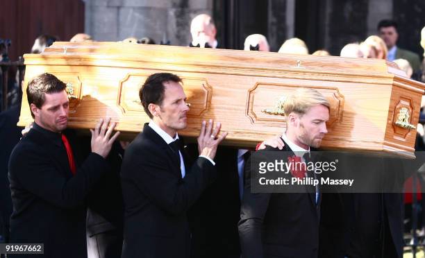 Keith Duffy and Ronan Keating carry the coffin of Boyzone member Stephen Gately on October 17, 2009 in Dublin, Ireland.