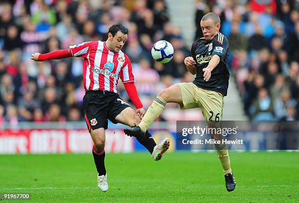 Andy Reid of Sunderland is challenged by Jay Spearing of Liverpool during the Barclays Premier League match between Sunderland and Liverpool at the...