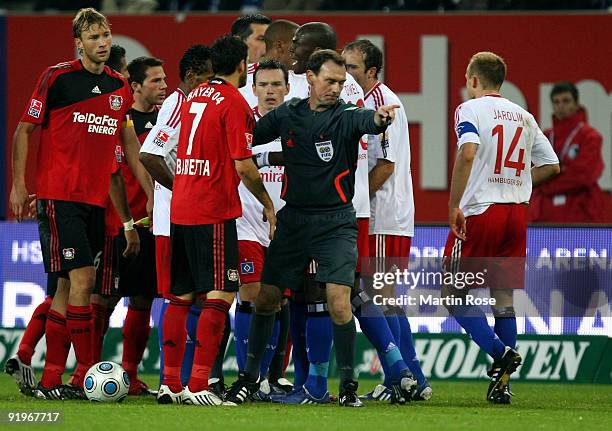 Referee Florian Meyer tries to stop the fight between players of Hamburg and Leverkusen during the Bundesliga match between Hamburger SV and Bayer...