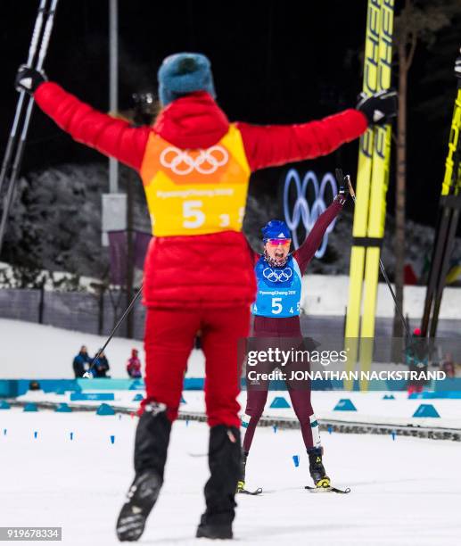 Russia's Anna Nechaevskaya celebrates with her teammates after the women's 4x5km classic free style cross country relay at the Alpensia cross country...