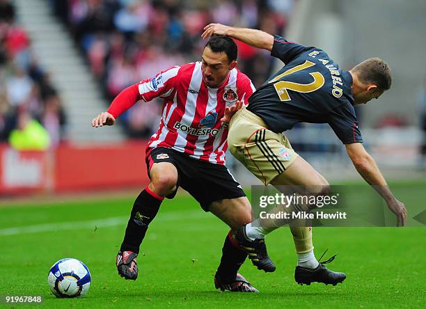 Steed Malbranque of Sunderland gets past Fabio Aurelio of Liverpool during the Barclays Premier League match between Sunderland and Liverpool at the...