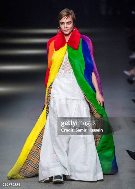 Cara Delevingne walks the runway at the Burberry show during London Fashion Week February 2018 at Dimco Buildings on February 17, 2018 in London,...