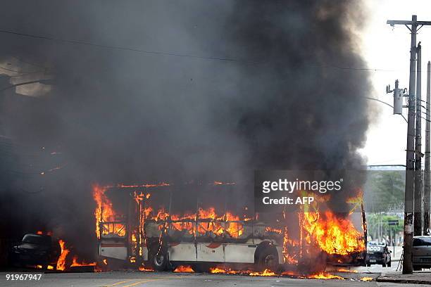 Public transportation bus set ablaze by drug dealers at Morro dos Macacos shantytown in Rio de Janeiro, Brazil burns October 17, 2009. Two police...