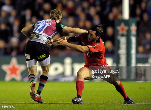 Byron Kelleher from Toulouse tackles David Strettle of Harlequins at the Twickenham Stoop in London, on October 17 during a European Cup rugby union...